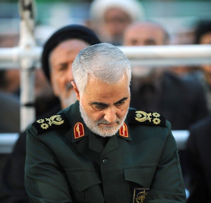 A handout picture provided by the office of the Iranian Ayatollah Ali Khamenei on June 04, 2019 shows Iranian Major General in the Islamic Revolutionary Guard Corps (IRGC) Qasem Soleimani listening to the Iranian supreme leader as delivers a speech on the occasion of the 30th death anniversary of the founder of the Islamic republic Ayatollah Ruhollah Khomeini, at his shrine in Tehran