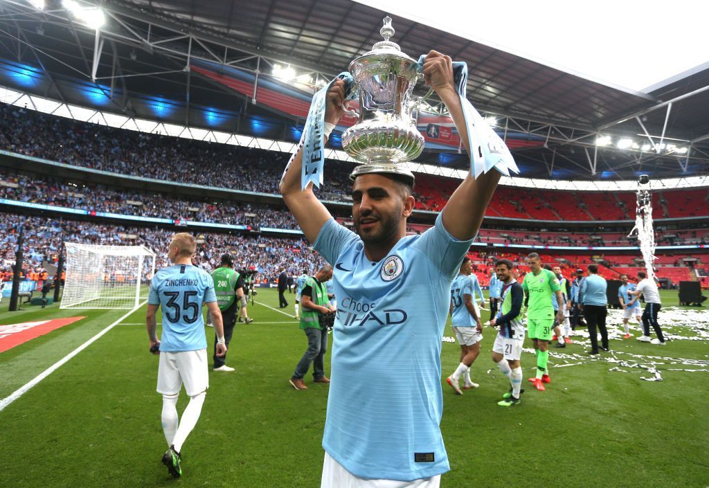 LONDON, ENGLAND - MAY 18: Riyad Mahrez of Manchester City celebrates with the trophy after victory in the FA Cup Final match between Manchester City and Watford at Wembley Stadium on May 18, 2019 in London, England. (Photo by Victoria Haydn/Man City via Getty Images)
