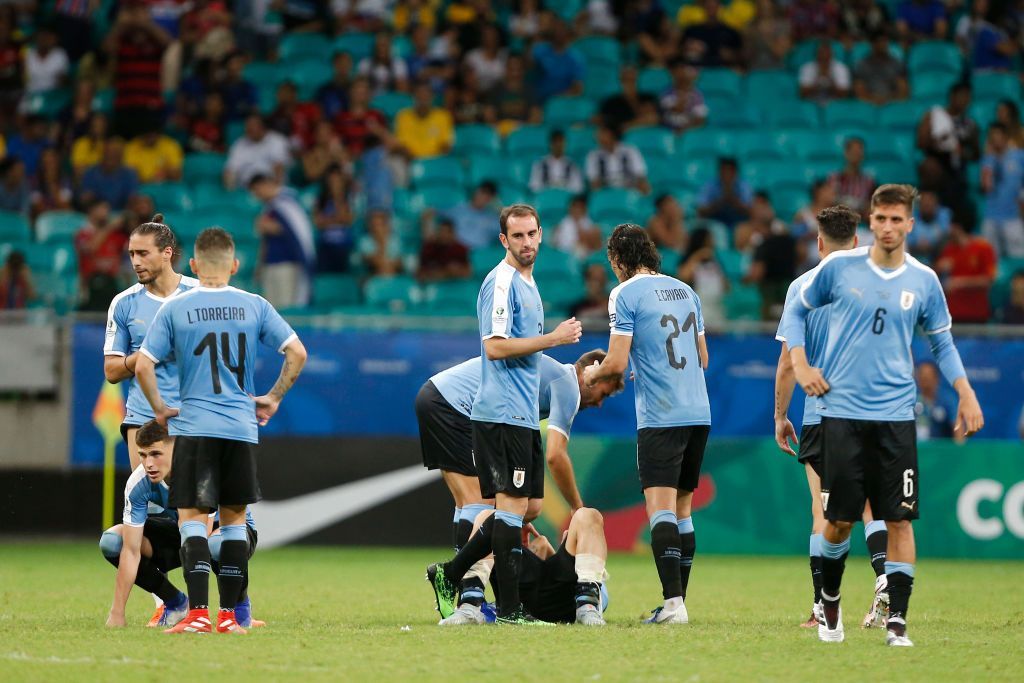 SALVADOR, BRAZIL - JUNE 29: Players of Uruguay comfort teammate Luis Suarez after losing during a penalty shootout after the Copa America Brazil 2019 quarterfinal match between Uruguay and Peru at Arena Fonte Nova on June 29, 2019 in Salvador, Brazil. (Photo by Wagner Meier/Getty Images)