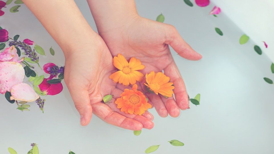 Beautiful young woman taking a herbal bath.