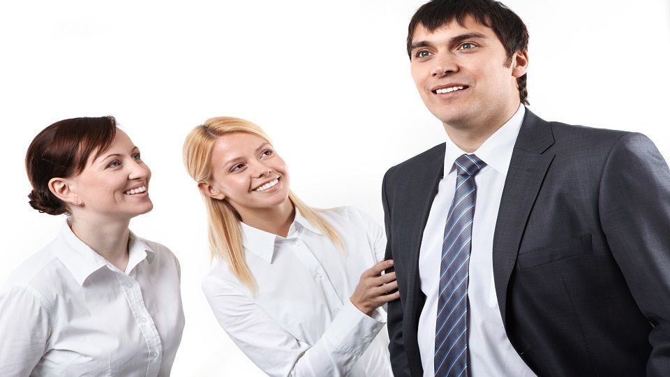 Two business woman looking at their manager