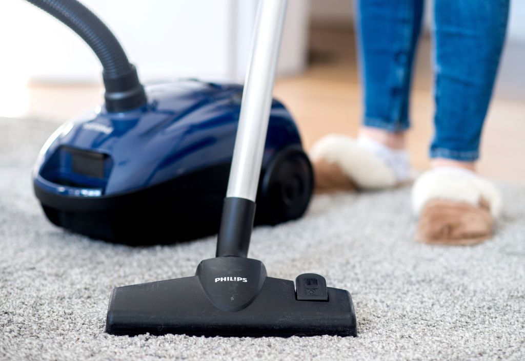 07 March 2019, Lower Saxony, Hannover: A woman in an apartment is vacuuming the floor with a Philips vacuum cleaner. Photo: Hauke-Christian Dittrich/dpa (Photo by Hauke-Christian Dittrich/picture alliance via Getty Images)