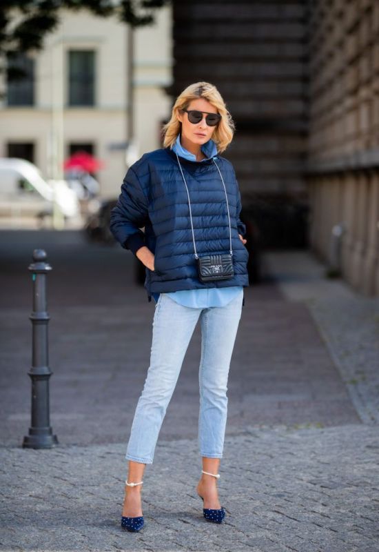 BERLIN, GERMANY - JULY 22: Gitta Banko is seen wearing a blue down sweater by Holubar, a blue blouse by Steffen Schraut, light blue jeans by Closed, navy and white polka dotted satin mules included ankle bracelets finished with pearlescent by Magda Butrym, black Prada micro bag and a black sunglasses by You Mawo on July 22, 2019 in Berlin, Germany. (Photo by Christian Vierig/Getty Images)