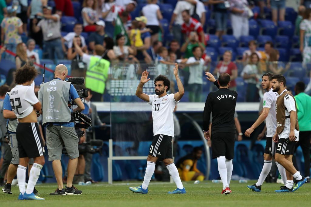 بعد غياب 21 عاما.. مصر تواجه جنوب أفريقيا (صور) 2 VOLGOGRAD, RUSSIA - JUNE 25: Mohamed Salah of Egypt shows appreciation to the fans following his sides defeat in the 2018 FIFA World Cup Russia group A match between Saudia Arabia and Egypt at Volgograd Arena on June 25, 2018 in Volgograd, Russia. (Photo by Catherine Ivill/Getty Images)