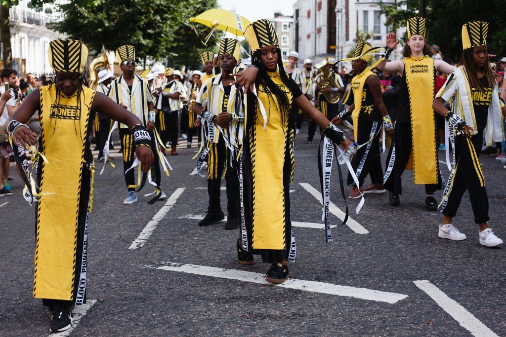 LONDON, UNITED KINGDOM - 2019/08/25: A dancing troupe performs at Westbourne Grove, during the opening day of the 2019 Notting Hill Carnival. Up to a million people are expected to pack the streets of Notting Hill and surrounding areas over the course of the two day event. The annual celebration of Afro-Caribbean culture takes place each August bank holiday weekend. (Photo by David Cliff/SOPA Images/LightRocket via Getty Images)