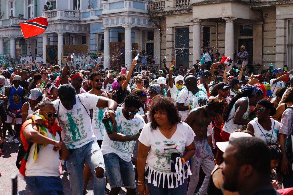 LONDON, UNITED KINGDOM - 2019/08/25: Revellers dance at Ladbroke Grove, during the opening day of the 2019 Notting Hill Carnival. Up to a million people are expected to pack the streets of Notting Hill and surrounding areas over the course of the two day event. The annual celebration of Afro-Caribbean culture takes place each August bank holiday weekend. (Photo by David Cliff/SOPA Images/LightRocket via Getty Images)