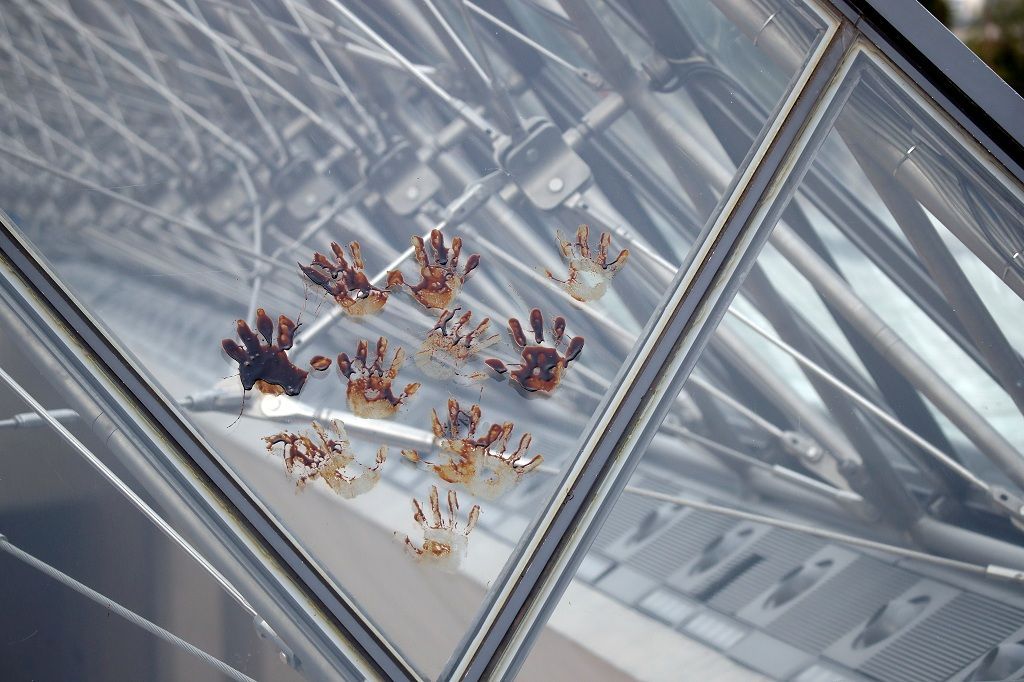 Fake oil-covered hands fingerprints are seen after an action by climate activist group 350.Org on the glass Pyramid at the Louvre museum in Paris, France, September 27, 2019. The Climate activist group protests against the sponsor partnership between Total and the Louvre museum. REUTERS/Charles Platiau