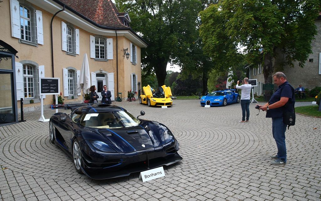 A Koenigsegg One:1 (2015), a Ferrari LaFerrari (2015) and a Bugatti Veyron EB 16.4 Coupe (2010), part of some 25 luxury cars owned by Teodoro Obiang, the son of the Equatorial Guinea's President Teodoro Obiang Nguema Mbasogo and confiscated by the Geneva prosecutorÕs office after a deal ending a money-laundering inquiry, are pictured during an auction preview of Bonhams at the Bonmont Golf & Country Club in Cheserex near Geneva, Switzerland September 27, 2019. REUTERS/Denis Balibouse