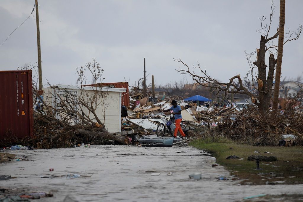 A man walks among debris at the Mudd neighborhood, devastated after Hurricane Dorian hit the Abaco Islands in Marsh Harbour, Bahamas, September 6, 2019. REUTERS/Marco Bello
