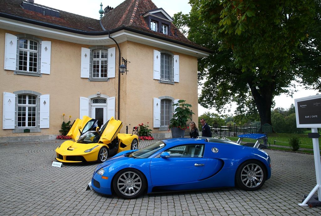 A Ferrari LaFerrari (2015) and a Bugatti Veyron EB 16.4 Coupe (2010), part of some 25 luxury cars owned by Teodoro Obiang, the son of the Equatorial Guinea's President Teodoro Obiang Nguema Mbasogo and confiscated by the Geneva prosecutorÕs office after a deal ending a money-laundering inquiry, are pictured during an auction preview of Bonhams at the Bonmont Golf & Country Club in Cheserex near Geneva, Switzerland September 27, 2019. REUTERS/Denis Balibouse