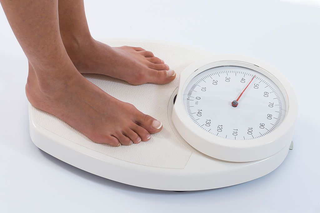 Woman on weight scale (Photo by: BSIP/Universal Images Group via Getty Images)