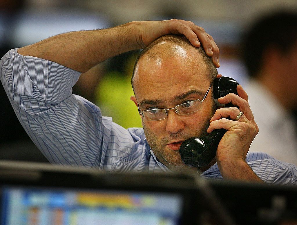 LONDON - OCTOBER 09: A broker on ICAP's dealing floor looks at prices on his screens on October 9, 2008 in London. Share prices are up on the day as markets react to the interest rate cut. (Photo by Peter Macdiarmid/Getty Images)