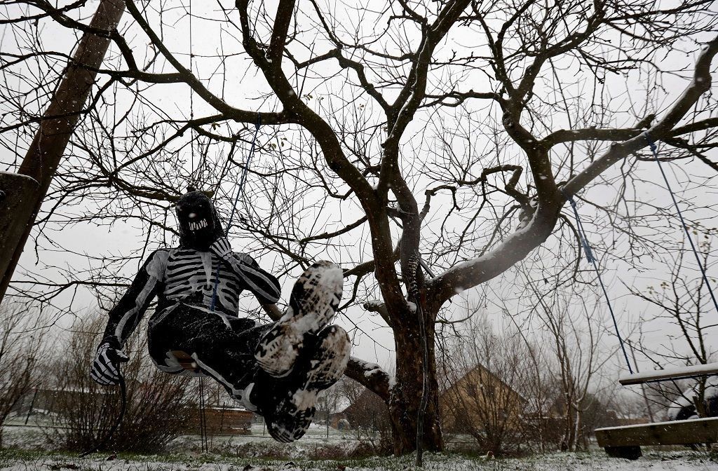 A reveller dressed as devil hangs from a tree in the village of Valasska Polanka during a traditional Saint Nicholas parade near the town of Vsetin, Czech Republic, December 7, 2019. REUTERS/David W Cerny
