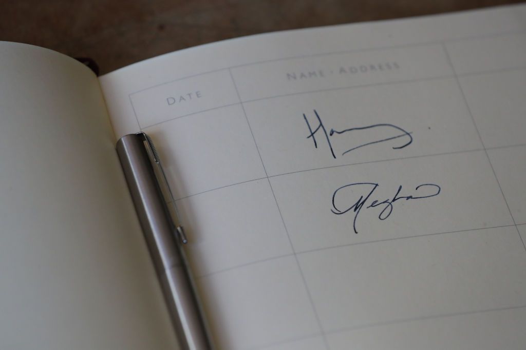 CHICHESTER, ENGLAND - OCTOBER 3: The signatures of Prince Harry, Duke of Sussex and Meghan, Duchess of Sussex are seen in the visitors book at Edes House during an official visit to Sussex on October 3, 2018 in Chichester, England. The Duke and Duchess married on May 19th 2018 in Windsor and were conferred The Duke & Duchess of Sussex by The Queen. (Photo by Daniel Leal-Olivas - WPA Pool/Getty Images)
