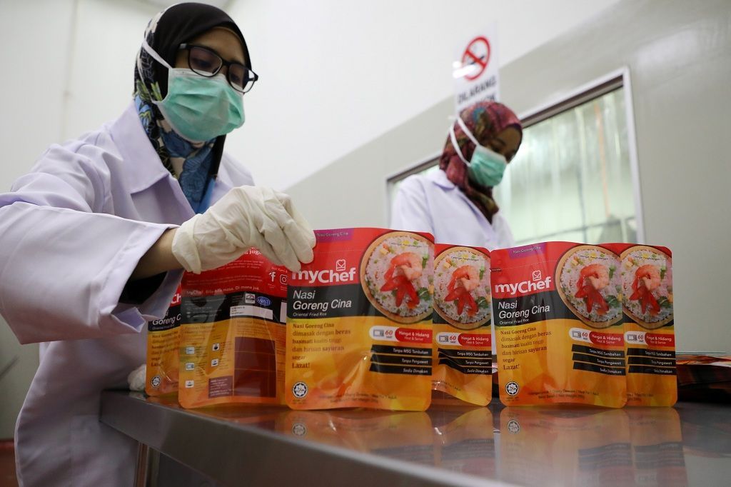 Workers arrange food packages at Mychef halal food factory in Kuala Lumpur, Malaysia, December 6, 2019. Picture taken December 6, 2019. REUTERS/Lim Huey Teng