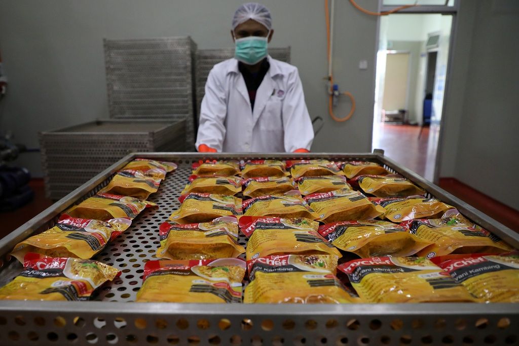 A worker moves food packages inside Mychef halal food factory in Kuala Lumpur, Malaysia, December 6, 2019. Picture taken December 6, 2019. REUTERS/Lim Huey Teng