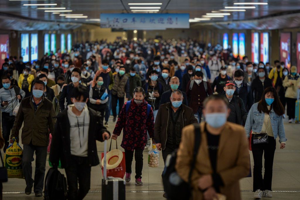 WUHAN, CHINA - APRIL 08 2020: Travelers walk to the exit of the Hankou Railway Station in Wuhan in central China's Hubei province Wednesday, April 08, 2020, after 76 days of lockdown of the city due to Covid-19.- PHOTOGRAPH BY Feature China / Barcroft Studios / Future Publishing (Photo credit should read Feature China/Barcroft Media via Getty Images)