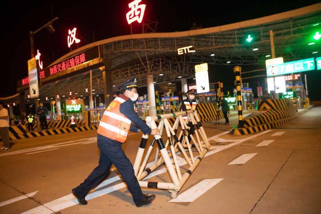 WUHAN, CHINA - APRIL 8, 2020 - Traffic police lift road blockade, Wuhan, Hubei Province, China, early morning April 8, 2020.- PHOTOGRAPH BY Costfoto / Barcroft Studios / Future Publishing (Photo credit should read Costfoto/Barcroft Media via Getty Images)