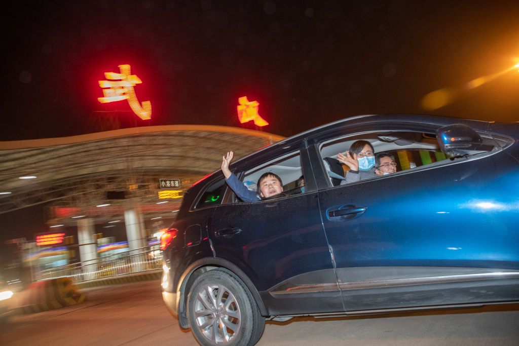 WUHAN, CHINA - APRIL 8, 2020 - Passengers wave before leaving Wuhan, Hubei Province, China, in the early hours of April 8, 2020.- PHOTOGRAPH BY Costfoto / Barcroft Studios / Future Publishing (Photo credit should read Costfoto/Barcroft Media via Getty Images)