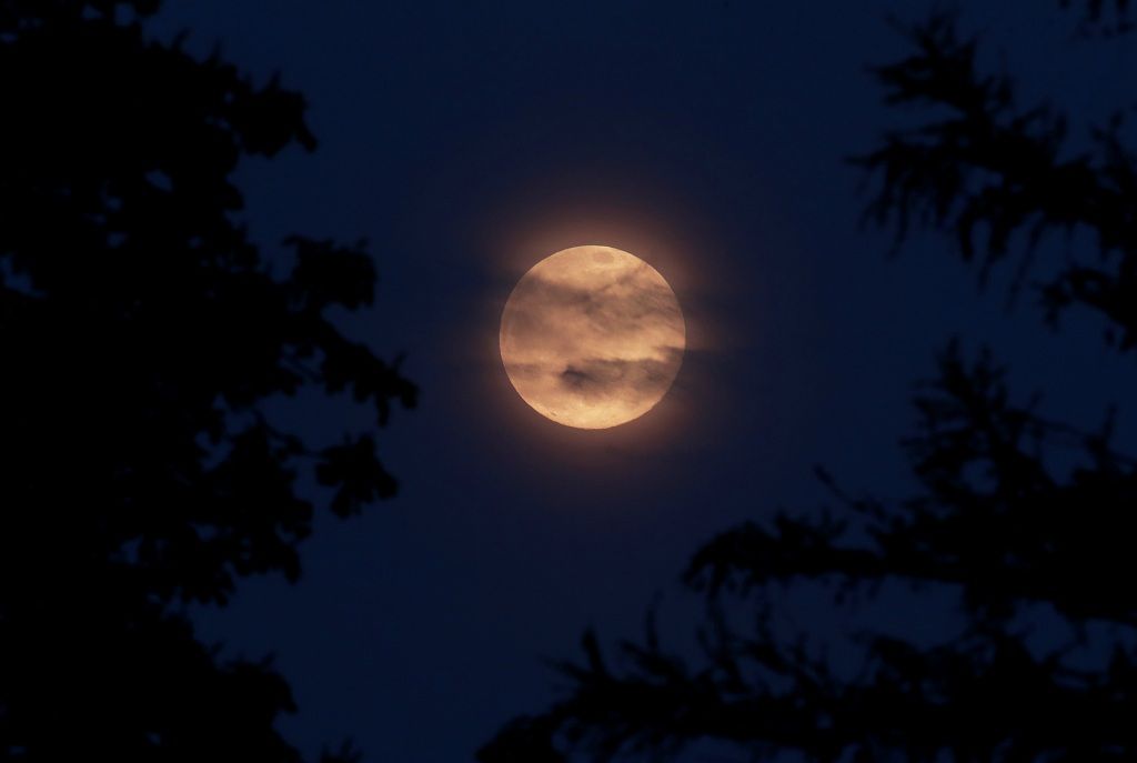 The Pink Supermoon rises over Windsor in an astronomical event that occurs when the moon is closest to the Earth in its orbit, making it appear much larger and brighter than usual, in Windsor, Britain, April 7, 2020. REUTERS/Andrew Couldridge