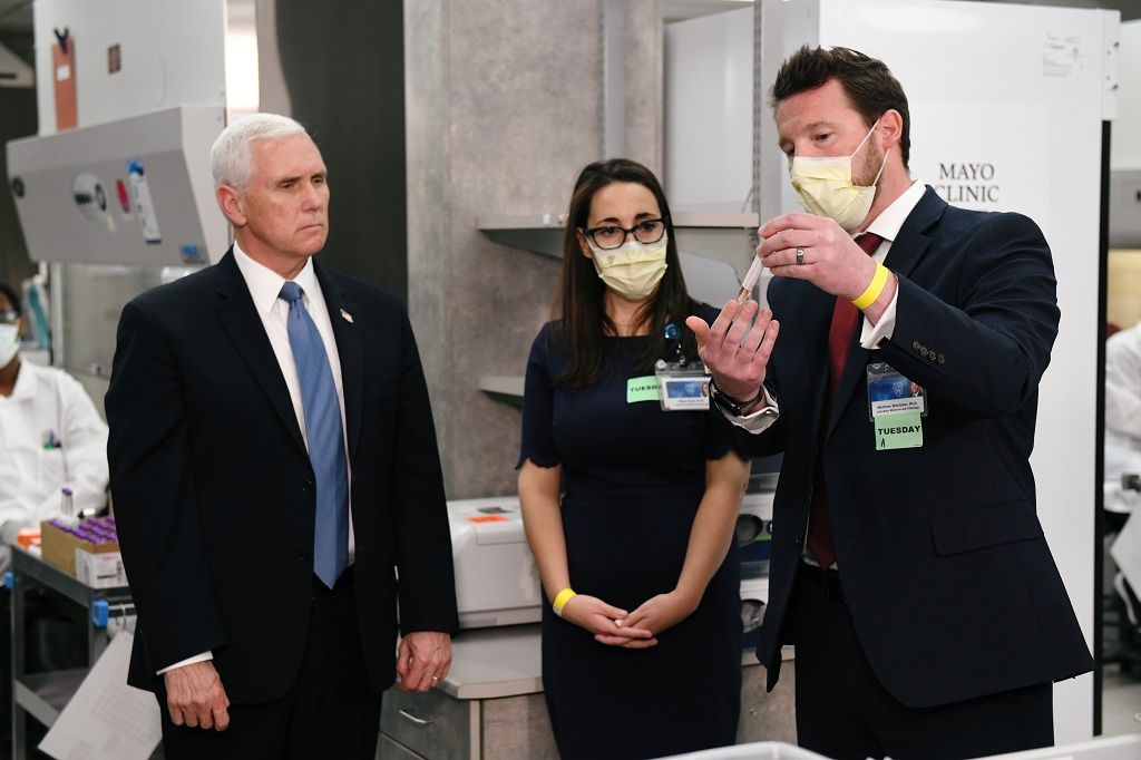 Vice President Mike Pence visits with lab physicians and techs while touring Mayo Clinic facilities supporting coronavirus disease (COVID-19) research and treatment in Rochester, Minnesota, U.S., April 28, 2020. REUTERS/Nicholas Pfosi