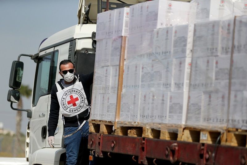A Palestinian worker rides on a truck carrying medical equipment donated by the International Committee of the Red Cross (ICRC) amid concerns about the spread of the coronavirus disease (COVID-19), at Kerem Shalom crossing in the southern Gaza Strip April 21, 2020. Picture taken April 21, 2020. REUTERS/Ibraheem Abu Mustafa