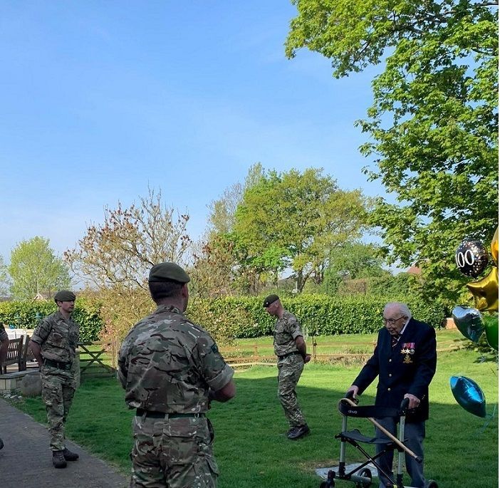 Veteran Capt Tom Moore talks to soldiers from 1st Battalion The Yorkshire Regiment who formed a Guard of Honour for the veteran as he completed his fundraising walk for the health services, in Bedfordshire, Britain, April 16, 2020. Ministry of Defence/Crown Copyright 2020/Handout via REUTERS THIS IMAGE HAS BEEN SUPPLIED BY A THIRD PARTY. NO RESALES. NO ARCHIVES