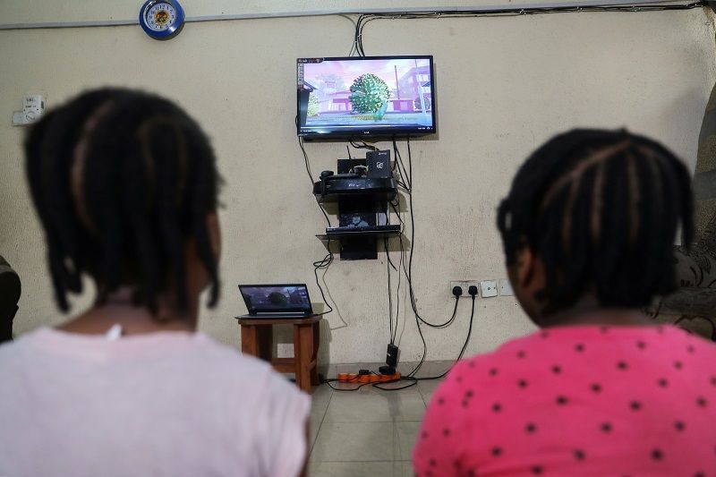 Kids watch an animation video created by Nigerian filmmaker, Niyi Akinmolayan to educate kids on coronavirus, in their home, amid the spread of the coronavirus disease (COVID-19), in Lagos, Nigeria April 17, 2020. Picture taken April 17, 2020. REUTERS/Temilade Adelaja