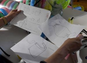 أستاذ مساعد في كلية التمريض بأمريكا يصنع دروعًا مخصصة للوجه في منزله 1 LAS VEGAS, NEVADA - APRIL 22: UNLV School of Nursing assistant professor Dr. Rhigel Jay Tan, a licensed nurse practitioner in psychiatric mental health, displays sketches he drew as he makes custom-made face shields called "iCareFaceShields" at his home for health care workers amid the coronavirus pandemic on April 22, 2020 in Las Vegas, Nevada. Dr. Tan designed the shields and can make them for about 40 cents each using a piece of polyethylene foam cut from a pool noodle, a sheet of projector transparency film, and an elastic band. He also makes cloth face masks that he calls "iCareMasks" for about USD 1.20. Since he began making them with help from friends and family about two weeks ago, Tan has donated more than 350 shields and 120 masks to Las Vegas-area hospitals and medical facilities. The World Health Organization declared the coronavirus (COVID-19) a global pandemic on March 11th. Ethan Miller/Getty Images/AFP