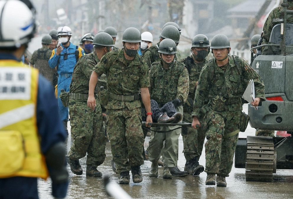 Japanese Self-Defence Force soldiers carry rescured person using a stretcher at a flooding site caused by a heavy rain in Kuma village, Kumamoto prefecture, southern Japan, in this photo taken by Kyodo July 5, 2020. Mandatory credit Kyodo/via REUTERS ATTENTION EDITORS - THIS IMAGE WAS PROVIDED BY A THIRD PARTY. MANDATORY CREDIT. JAPAN OUT. NO COMMERCIAL OR EDITORIAL SALES IN JAPAN.