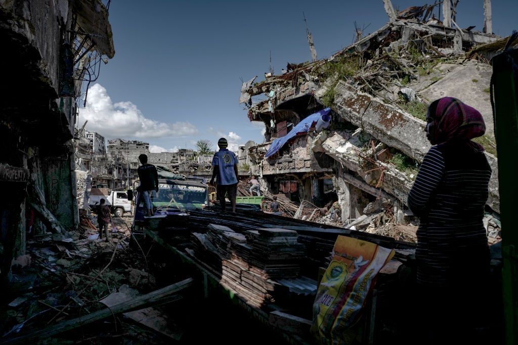 MARAWI, PHILIPPINES - MAY 10: Marawi residents salvage any usable items they can find from what is left of their homes as they were allowed to enter for three days in what used to be the main battle area during the war, on May 10, 2018 in Marawi, Philippines. With their homes destroyed and their properties looted or burned, thousands of families displaced during the Marawi siege which began on May 23, 2017, the holy month of Ramadan brings a wave of painful memories since Islamic State loyalists, Maute and Abu Sayyaf, took over large parts of Marawi City. Muslims all over the world, including those in Southern Philippines, stocked up on groceries last week as they began the month of Ramadan, a period when they are dedicated to fasting from sunrise-to-sundown, prayer and charity. With an estimated 27,000 families still living in evacuation centers and transition houses, many wonder when they can go home since around half of the city's infrastructure was destroyed during the five-month-long battle and martial law continues to be in place across Mindanao. President Rodrigo Duterte visited Marawi again this month pledging to provide amnesty for Maute rebels who are willing to surrender with hopes to bring momentary peace to the embattled southern island. Duterte did not make any visit to the evacuees, whose concerns remains whether reconstruction will be channeled into building an industrial zone and another military camp rather than restoring their homes and businesses to its original state. Government authorities estimates that residents can start rebuilding their houses in 2020. (Photo by Jes Aznar/Getty Images)