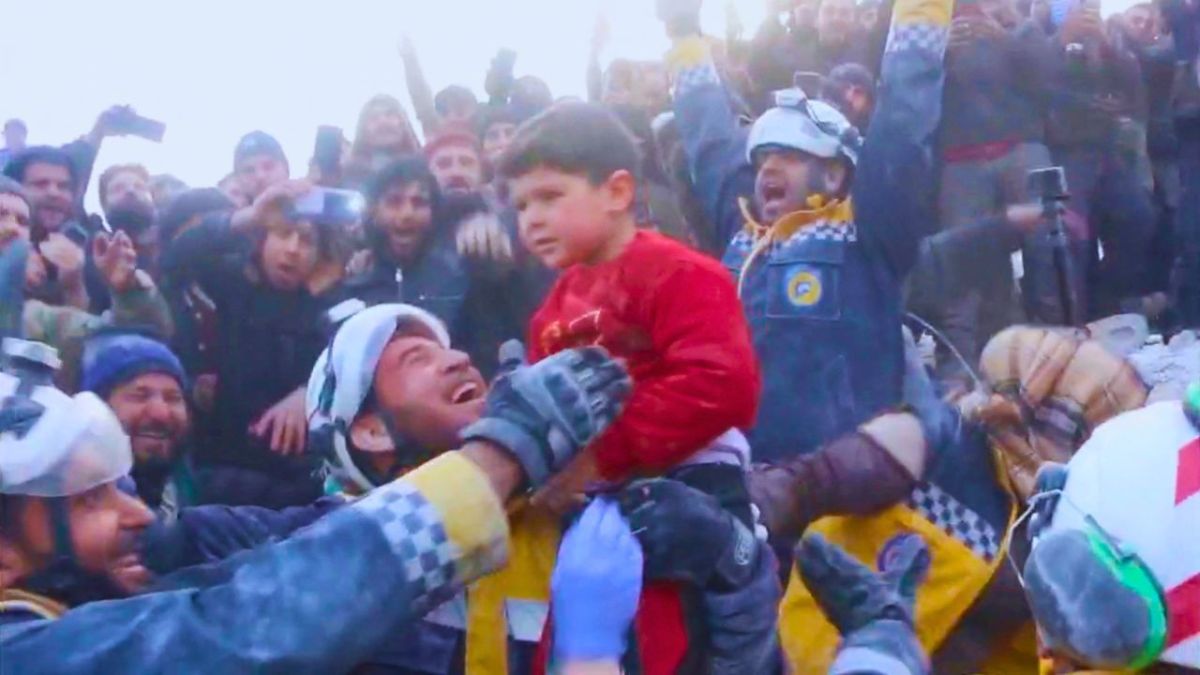 عناصر الخوذ البيضاء يعبرون عن فرحتهم بانقاذ طفل من تحت الأنقاض- رويترز