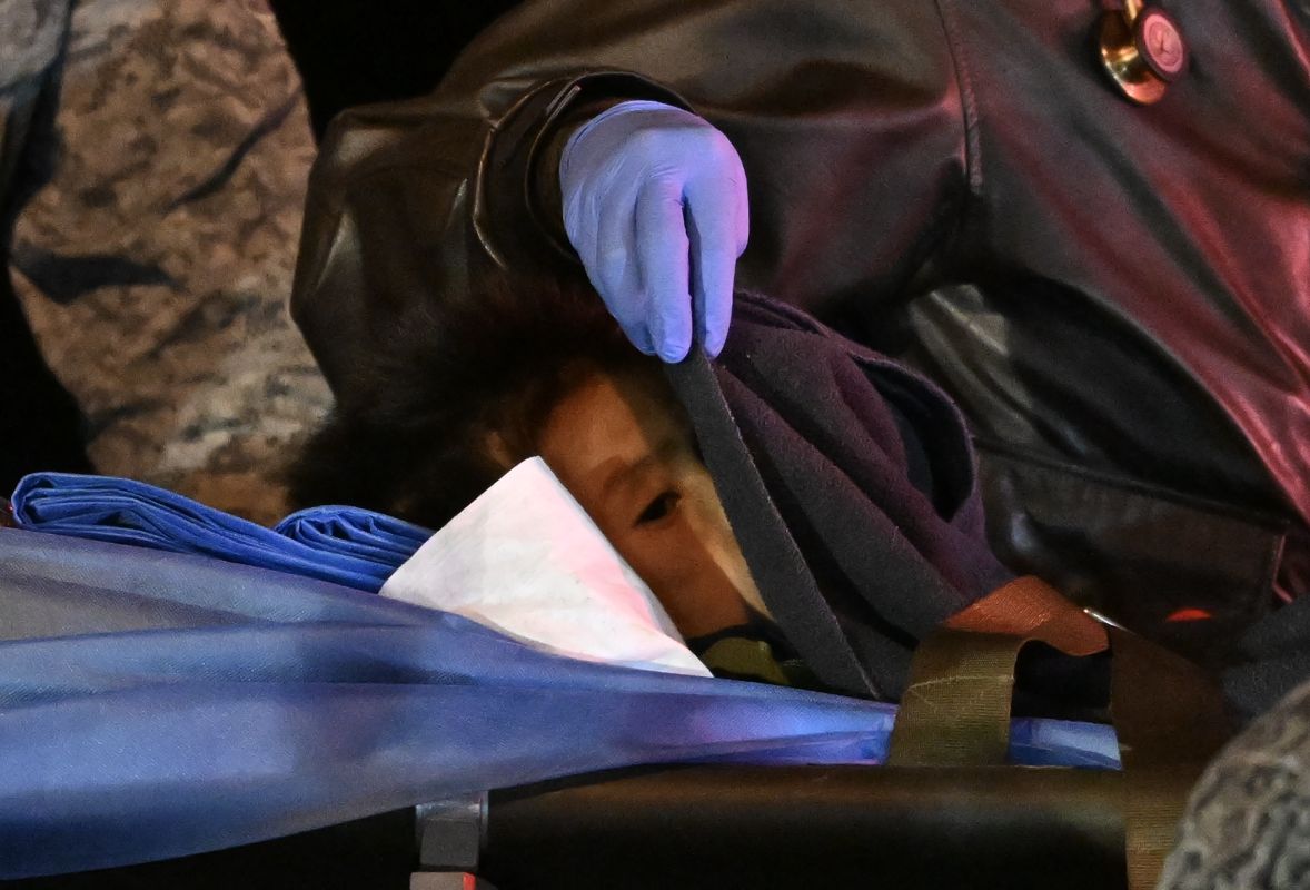 One of the four Indigenous children who were found alive after being lost for 40 days in the Colombian Amazon forest following a plane crash, is stretchered out of a plane upon landing at the CATAM military base in Bogota on June 10, 2023. - Four Indigenous children who had been missing for more than a month in the Colombian Amazon rainforest after a small plane crash have been found alive, President Gustavo Petro said on June 9, 2023. (Photo by Juan BARRETO / AFP)